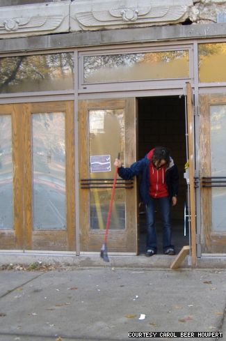 A student sweeps out the Empress Theatre.
